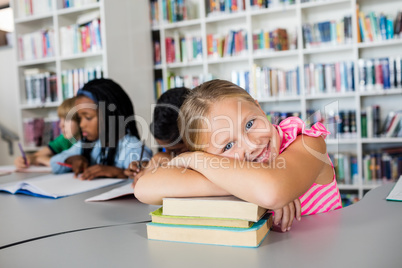 Little girl posing arm crossed at desk