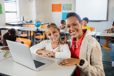 Happy teacher and pupil posing