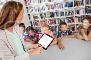 Teacher using tablet with pupils