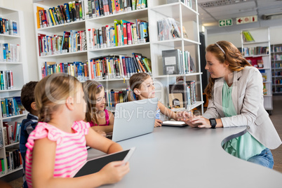 Teacher using technology with pupils