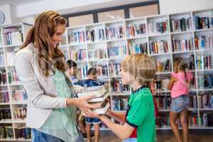 Teacher giving books to her students