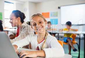 Child posing with her computer
