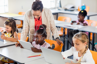 Teacher giving lesson to her students with technology