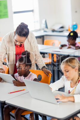 Teacher giving lesson to her students with technology