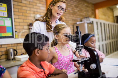 Teacher giving lesson to her students