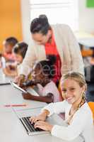 Teacher giving lesson to her students with technology