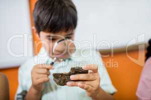 Children looking fossils with a magnifying glass