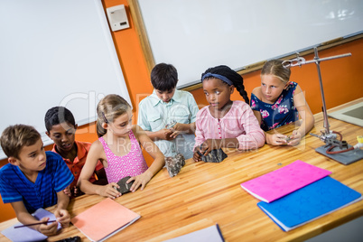 Children posing with fossils