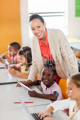 Teacher giving lesson to her students with technology