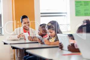 Teacher giving lesson to her students with technology