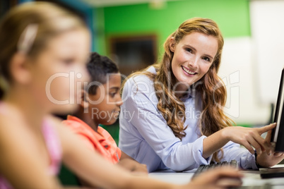 Teacher giving lesson to her students with technology