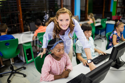 Teacher giving lesson to her students with technology