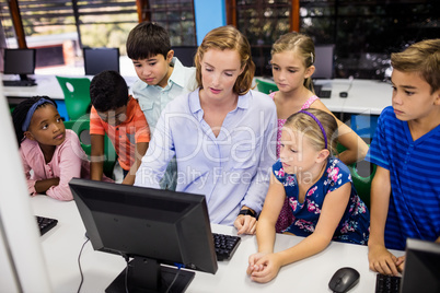 Teacher giving lesson to her students with technology