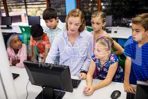 Teacher giving lesson to her students with technology