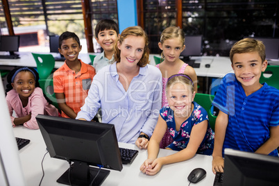 Teacher giving lesson to her students with technology