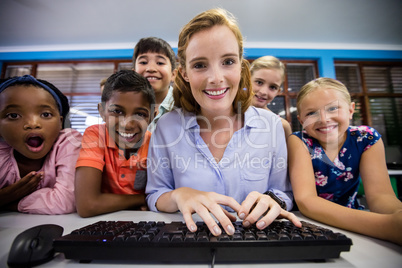 Teacher giving lesson to her students with technology