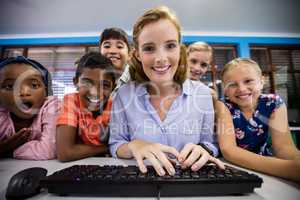 Teacher giving lesson to her students with technology