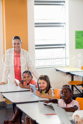 Teacher giving lesson to her students with technology