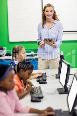 Teacher giving lesson to her students with technology