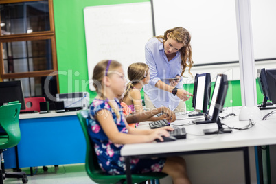 Teacher giving lesson to her students with technology