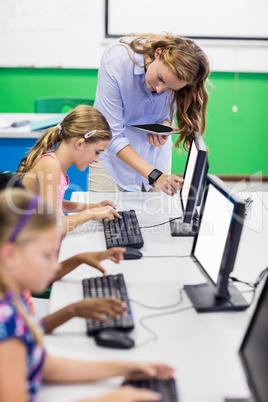 Teacher giving lesson to her students with technology