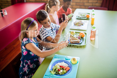 Children using technology during lunch