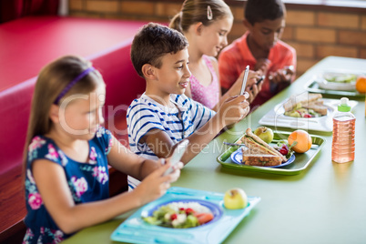 Children using technology during lunch