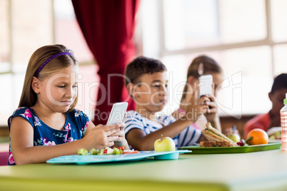 Children using technology during lunch