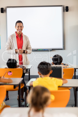 Teacher giving lesson to her students