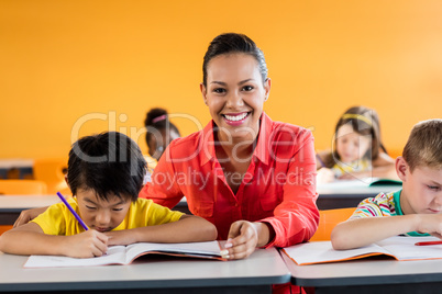 Teacher giving lesson to her students