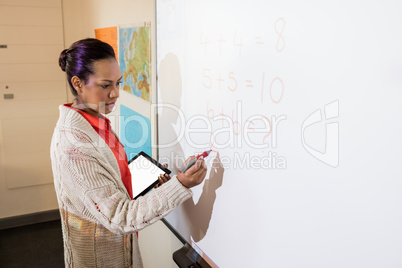 Teacher giving lesson to her students
