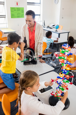 Teacher giving lesson to her students