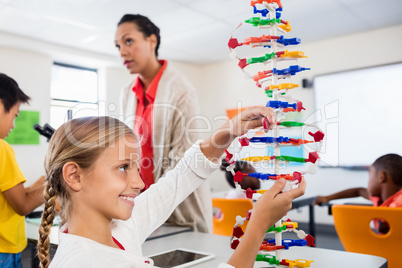 Child posing with her atoms creation