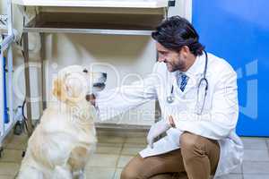 A man vet petting a dog