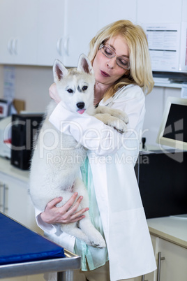 A woman vet bringing a dog