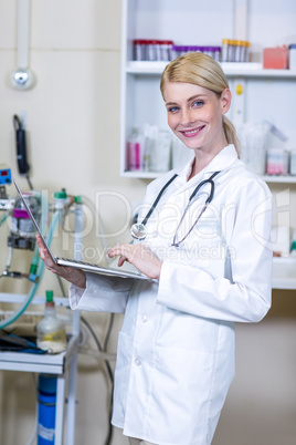 Portrait of woman vet using her laptop