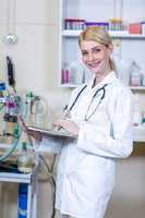 Portrait of woman vet using her laptop