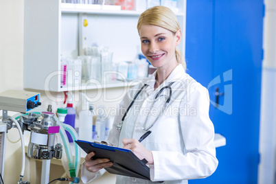 Portrait of woman vet taking notes