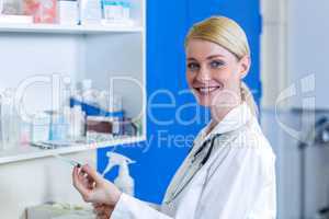 Portrait of woman vet bringing a syringe