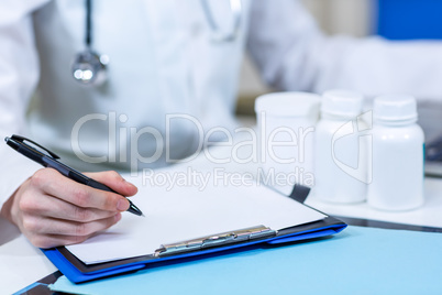 Close up of woman vet writing