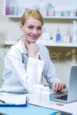 Portrait of woman vet working with her laptop