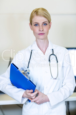 Portrait of woman vet bringing a clipboard