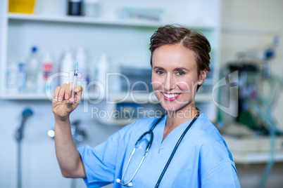A woman vet bringing a syringe