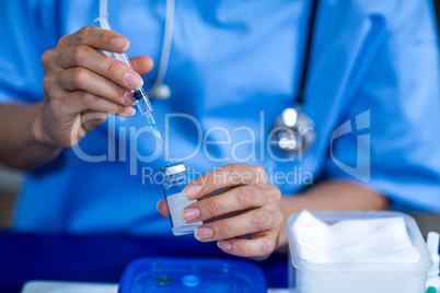 Close up of woman holding syringe