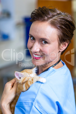 Portrait of woman vet bringing a kitten