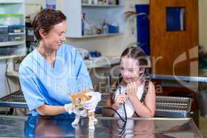 A little girl using the stethoscope like the vet