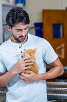 Portrait of man holding a cute kitten