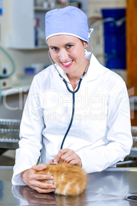 Portrait of woman vet examining kitten