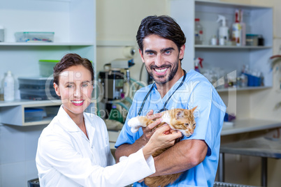 Portrait of two vets holding a cat