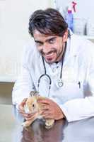 Portrait of vet holding a cute rabbit
